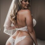 A woman in a white lingerie and veil.